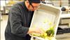 The executive chef at Affairs to Remember in Atlanta places back-of-the-house food waste into composting bins.